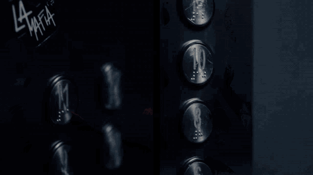 a person is pressing a button in an elevator that says ' a ' on it