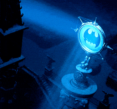 a batman logo is lit up in a dark area