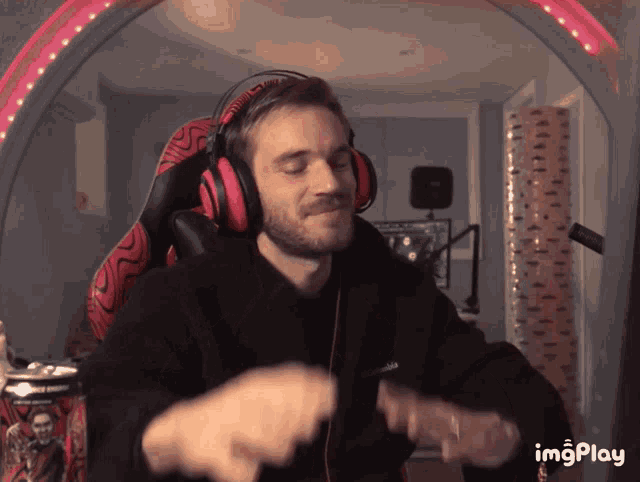 a man wearing headphones and a black jacket is dancing