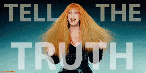 a woman with long red hair stands in front of a sign that says " tell the truth "