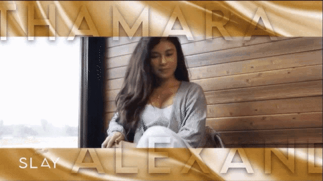 a woman is sitting in front of a wooden wall with the name thamara slay alexant written on the bottom