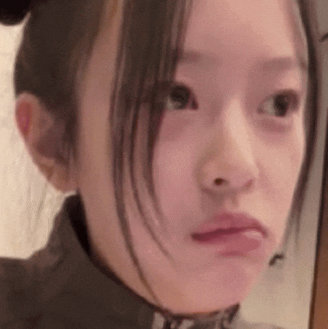 a close up of a woman 's face making a face .