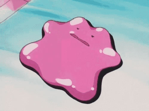 a pink cartoon character with a face is sitting on a blue surface .