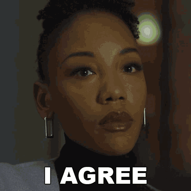 a close up of a woman 's face with the words " i agree " below her