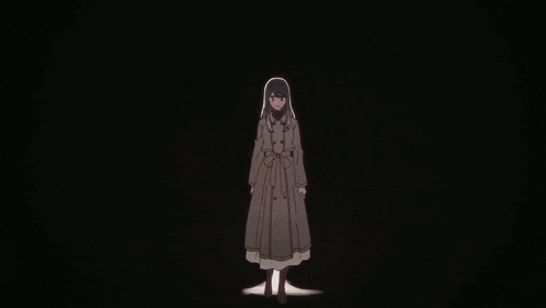 a woman in a trench coat is standing in a dark room with a light behind her