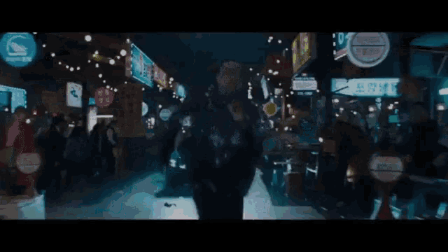a blurred image of a person walking down a street with a sign that says ' t.i.m. '