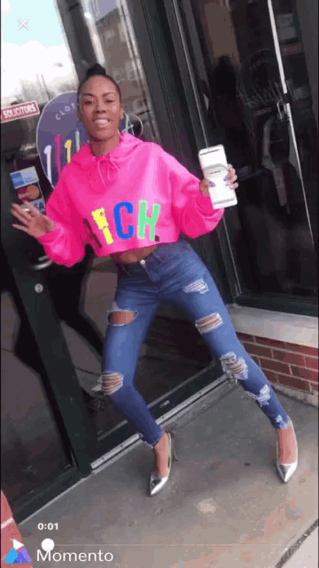 a woman wearing a bright pink sweater that says nch