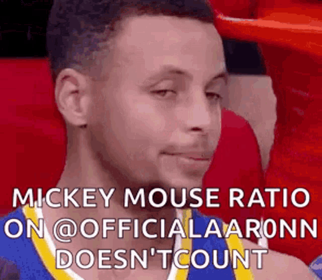 a basketball player is sitting in the stands during a game and talking about mickey mouse .