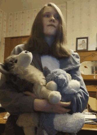 a woman holding a stuffed animal in her arms