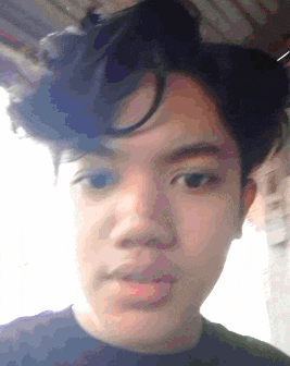 a close up of a young man 's face with a slight smile on his face