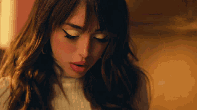 a close up of a woman 's face with her eyes closed and her mouth open