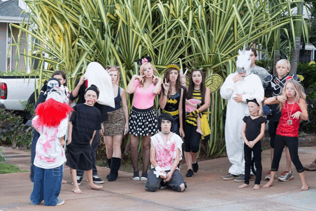 a group of children dressed up in halloween costumes pose for a picture