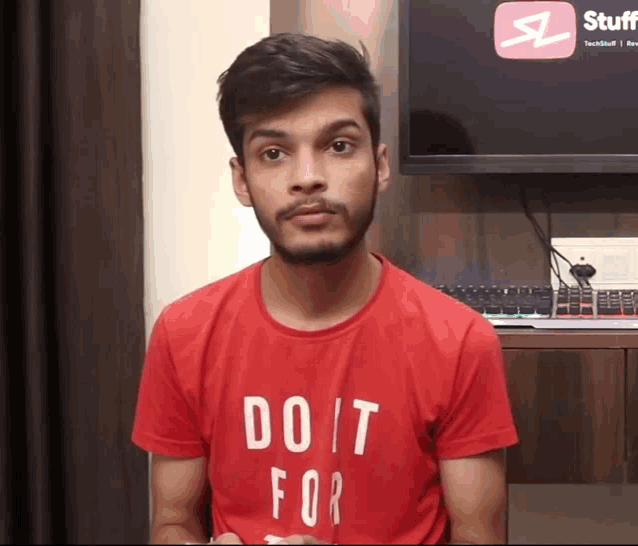a young man wearing a red shirt that says do it for