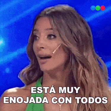 a woman with a microphone in her mouth says " esta muy enojada con todos "
