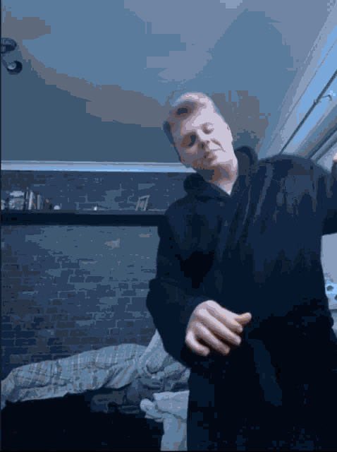 a man in a black robe is dancing in a room
