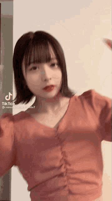 a tiktok video of a girl in a pink top
