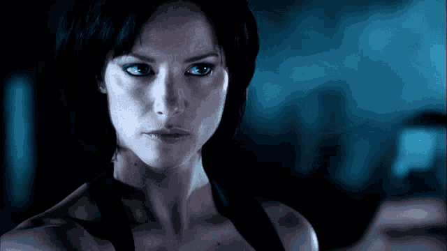 a close up of a woman 's face with a dark background