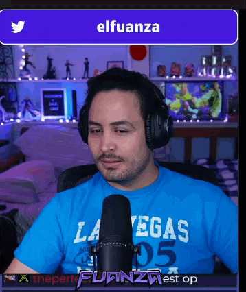 a man wearing headphones and a blue shirt with the word las vegas on it