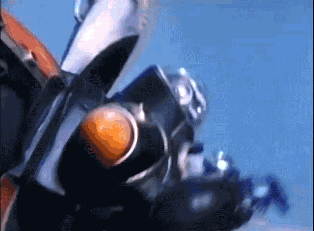a robot is flying through the air with a blue sky behind it