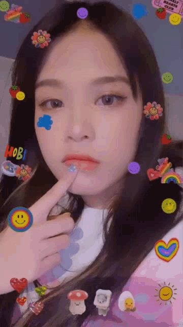 a girl with stickers on her face including one that says hobi on it