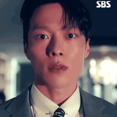 a close up of a man 's face with sbs written on the bottom