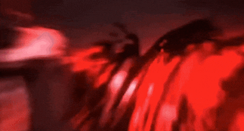 a blurred image of a red light coming out of a pipe .