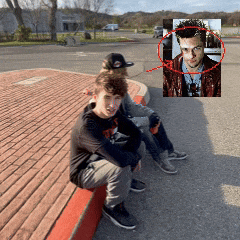 two boys are sitting on a red brick curb with a picture of a man in a red jacket behind them