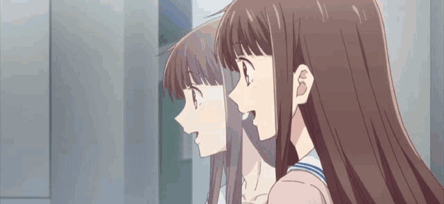 two anime girls with long hair are standing next to each other and looking at something .