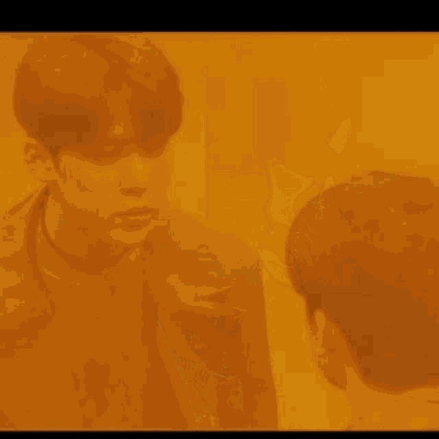 a couple of people are standing next to each other in a dark room .