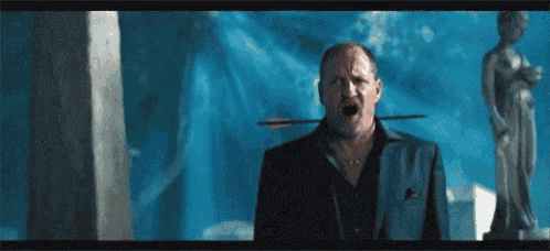 a man with an arrow sticking out of his mouth .