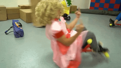 a woman in a pink dress is sitting on a skateboard