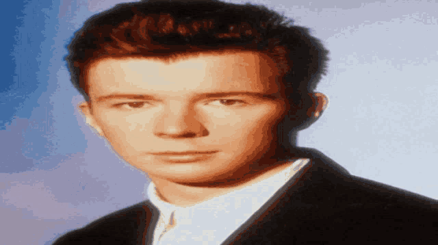 a close up of a man 's face in a suit and tie