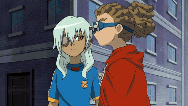 a boy in a blue shirt with the letter l on it stands next to another boy in a red hoodie