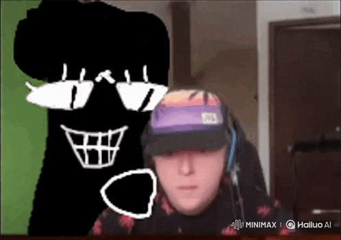 a man wearing headphones and a hat is standing in front of a drawing of a skull