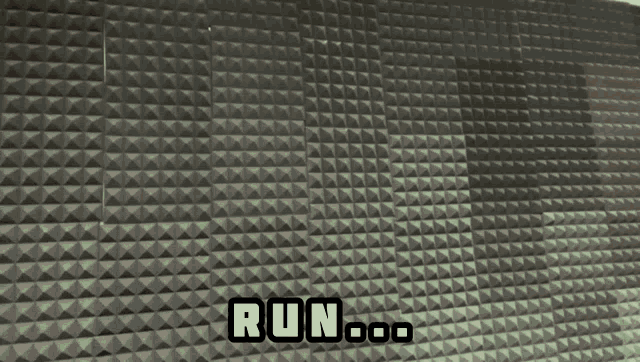 a man standing in front of a wall that says run on it