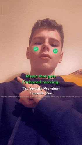 a young man with spotify stickers on his face says music that gets i 'm bored moving