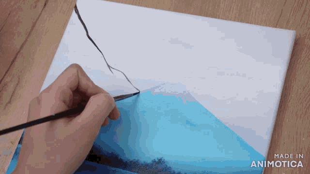 a person is painting a mountain on a canvas with the words made in animatica below it