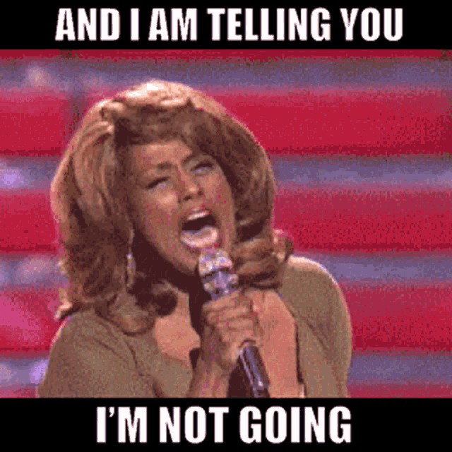 a woman singing into a microphone with the words and i am telling you i 'm not going