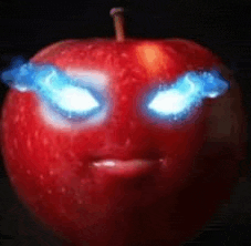 a red apple with blue eyes that looks like a devil .