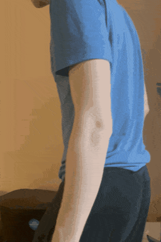a man wearing a blue shirt and black pants