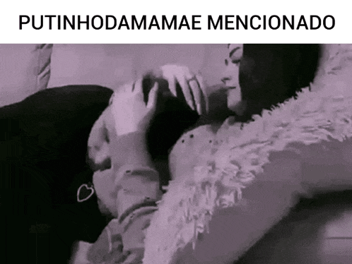 a man and a woman are laying on a couch and kissing each other .