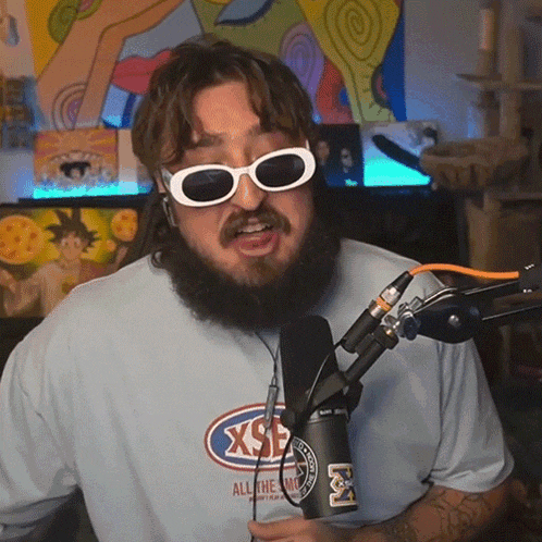 a man wearing sunglasses and a shirt that says xsf on it