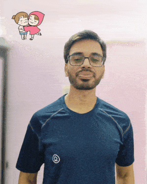 a man wearing glasses stands in front of a pink wall with a cartoon of a man holding a girl