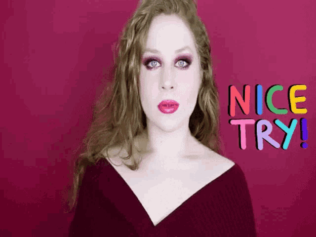 a woman stands in front of a pink background with the words nice try