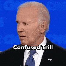 a man in a suit and tie with the words confused trill on his face