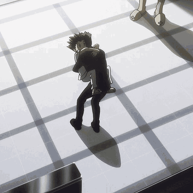 a man is hugging another man on a tile floor