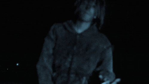 a blurred image of a person in a dark room