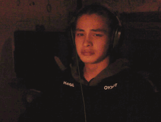 a man wearing headphones with the word oyjt on his sleeve