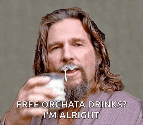 a man with a beard is drinking milk and says free orchata drinks