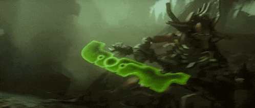 a person is holding a green sword in a dark cave .